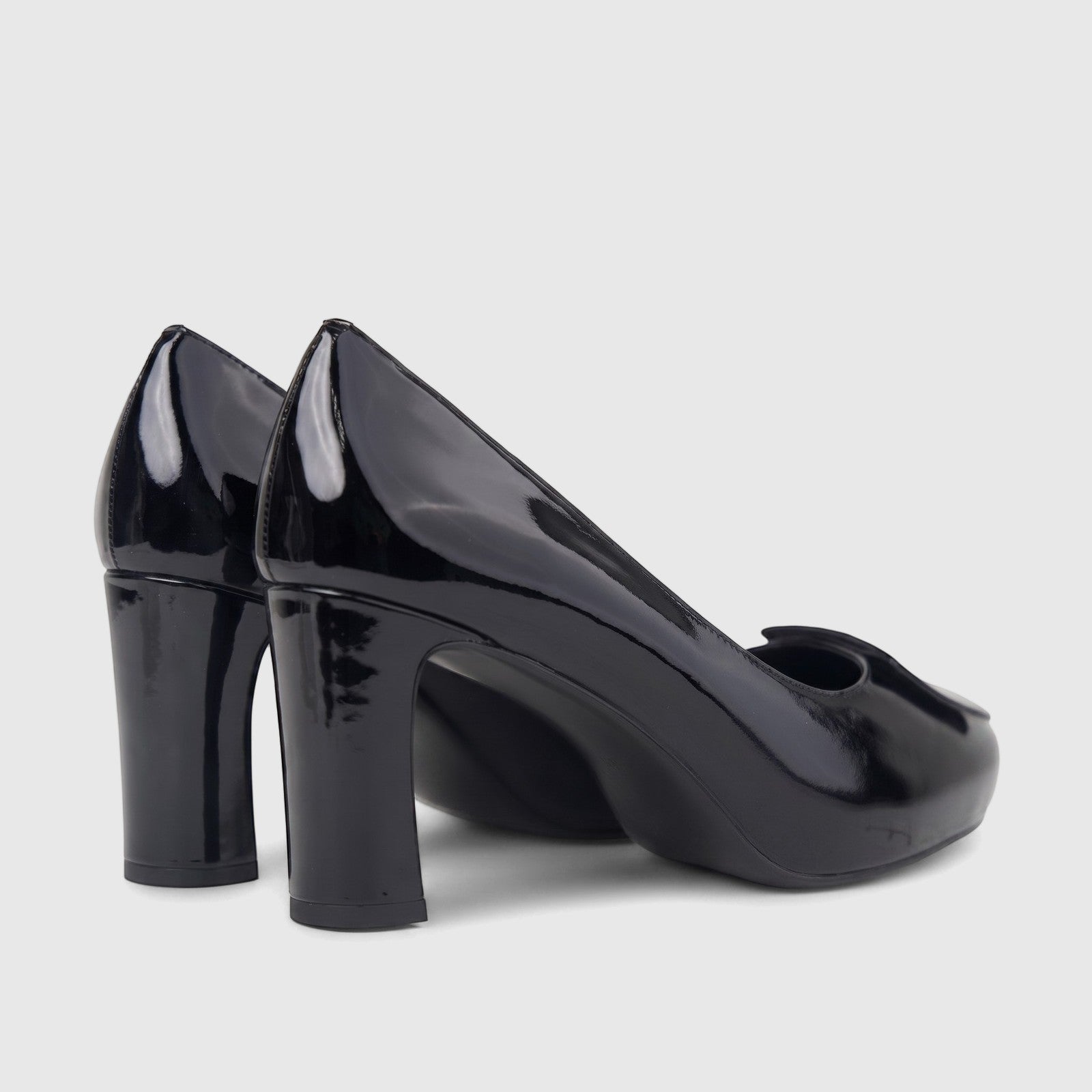 A pair of shiny black patent leather Morbido ladies dress court shoes with block heels, viewed from a slightly elevated side