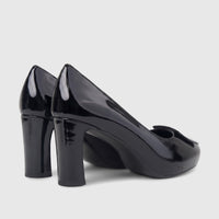 A pair of shiny black patent leather Morbido ladies dress court shoes with block heels, viewed from a slightly elevated side
