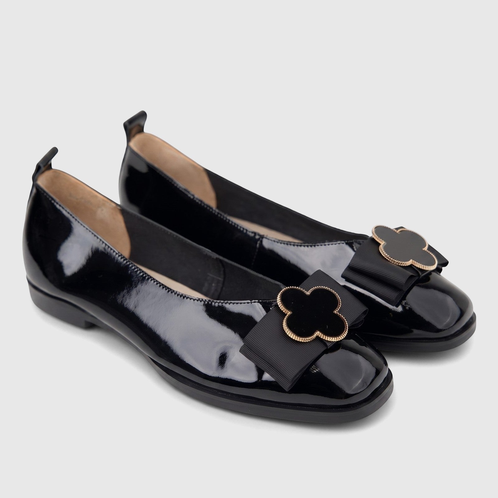 Morbido Ladies black patent leather pumps, featuring square toes and decorative black ribbon bows with gold-rimmed clover