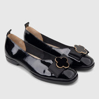 Morbido Ladies black patent leather pumps, featuring square toes and decorative black ribbon bows with gold-rimmed clover