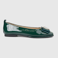 Dark green patent leather Morbido ladies pump with a decorative bow and silver buckle detail, viewed from the side.