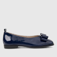 Side view of a Morbido Ladies Leather Pump in dark blue patent leather, featuring a decorative bow on the front.