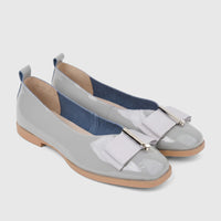 A pair of Morbido Ladies Leather Pumps BIL-021 in light grey patent leather with elegant bow details and square toes.