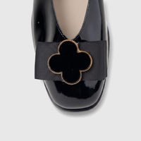 Morbido Ladies Leather Pump BIL-025 Black BN10. Close-up of a glossy black patent leather pump with a black grosgrain ribbon