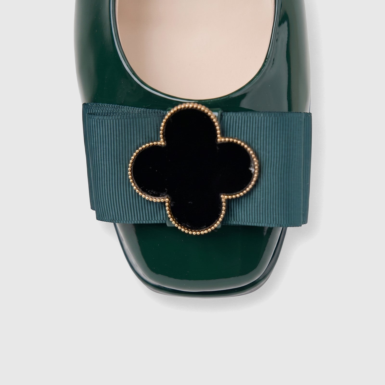 Morbido Ladies Leather Pump in dark green patent leather, featuring a teal grosgrain ribbon and a decorative clover buckle.