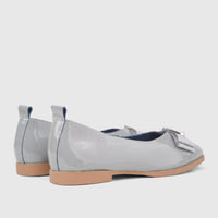 Morbido Ladies Leather Pumps in light grey patent leather, featuring a bow detail and a low heel, viewed from the side and