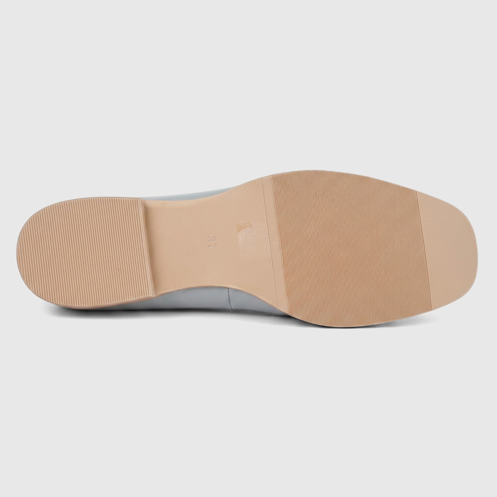 Light grey Morbido ladies leather pump, showing the ribbed tan sole and flat heel from a side view.