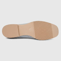 Light grey Morbido ladies leather pump, showing the ribbed tan sole and flat heel from a side view.