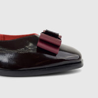 Morbido Ladies Leather Pump in wine red patent leather with a decorative bow on the toe.