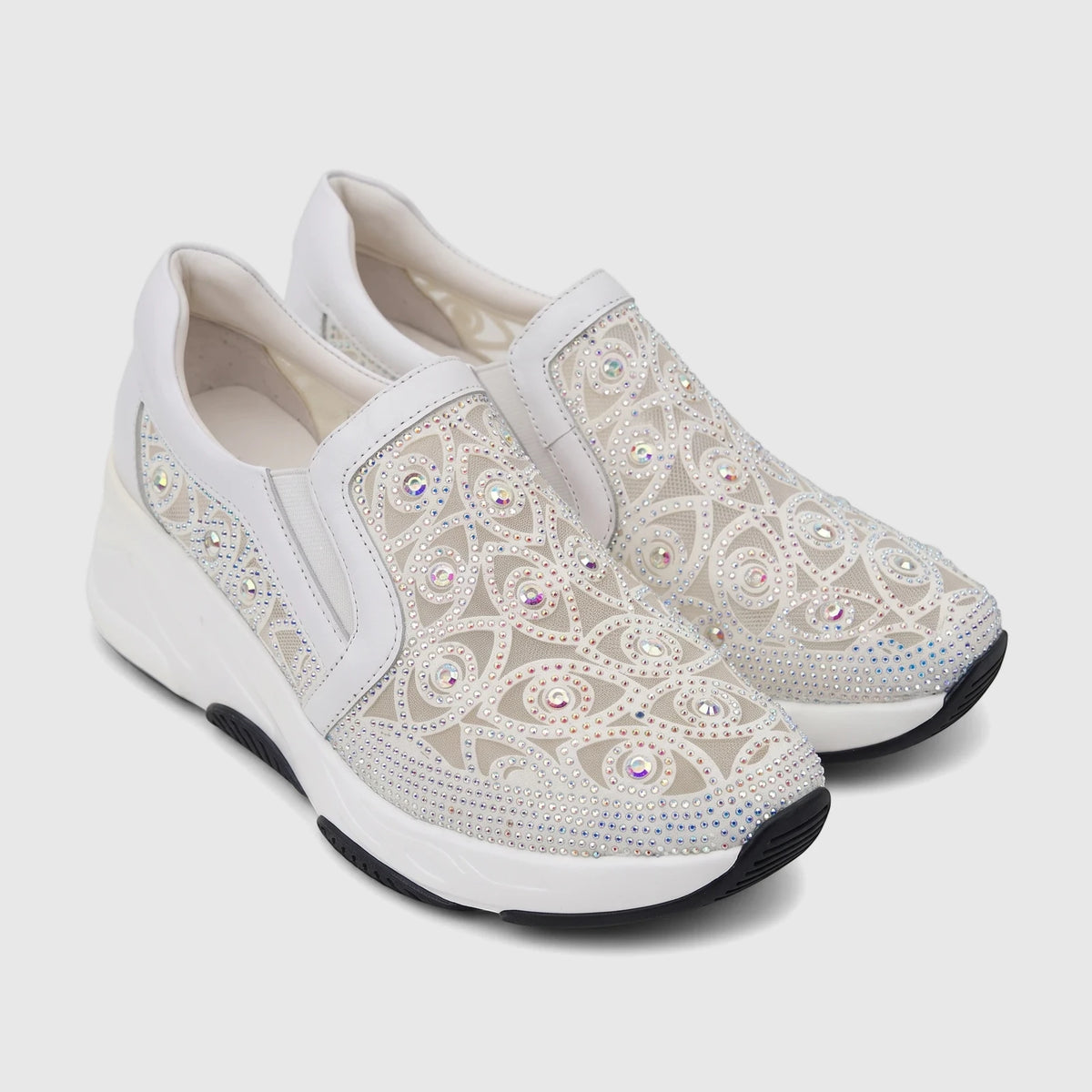 White Morbido Ladies Leather Slip-On Sneakers with rhinestone embellishments and a comfortable wedge sole.