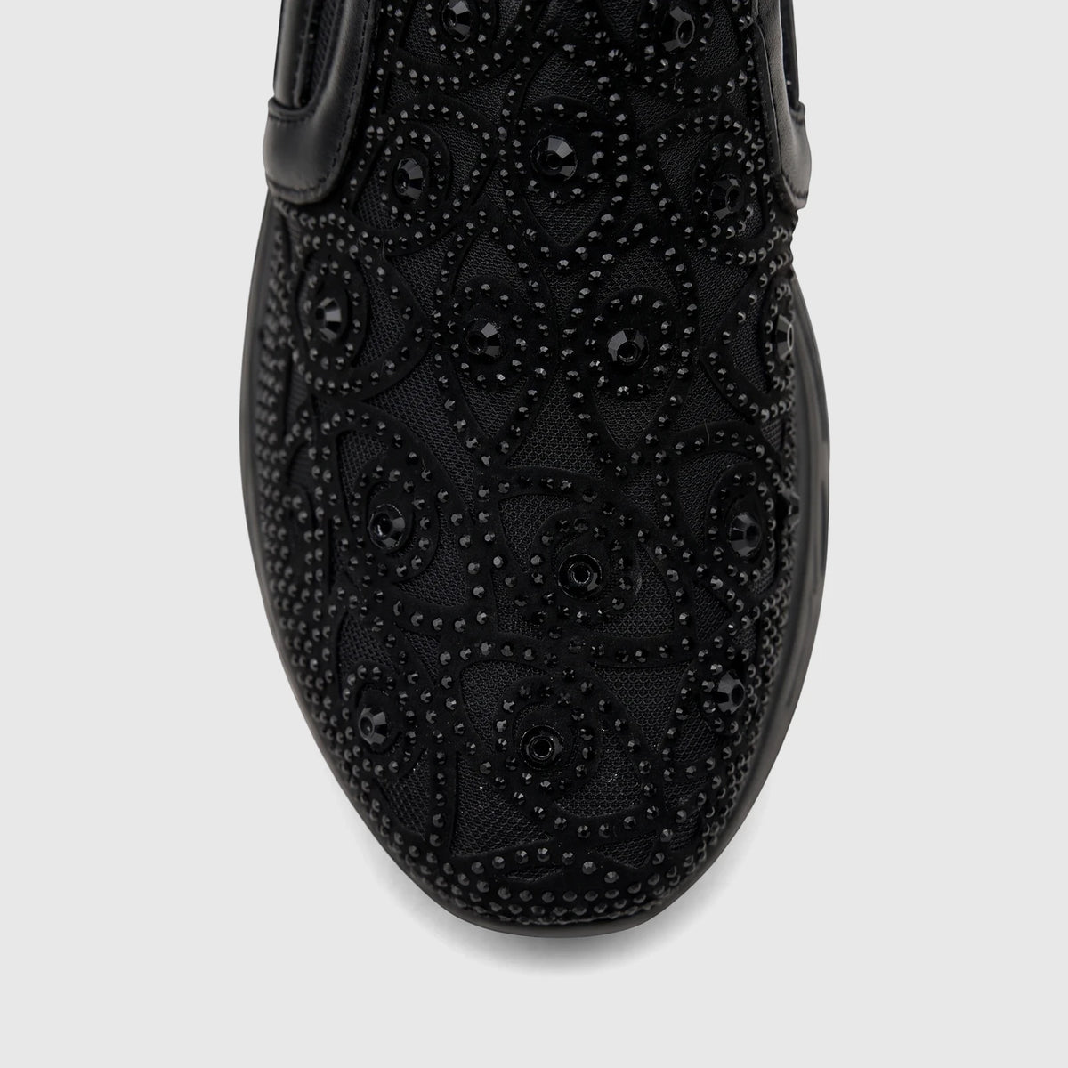 Close-up view of a black Morbido Ladies Leather Sneaker with intricate beaded embellishments on the toe box and vamp.