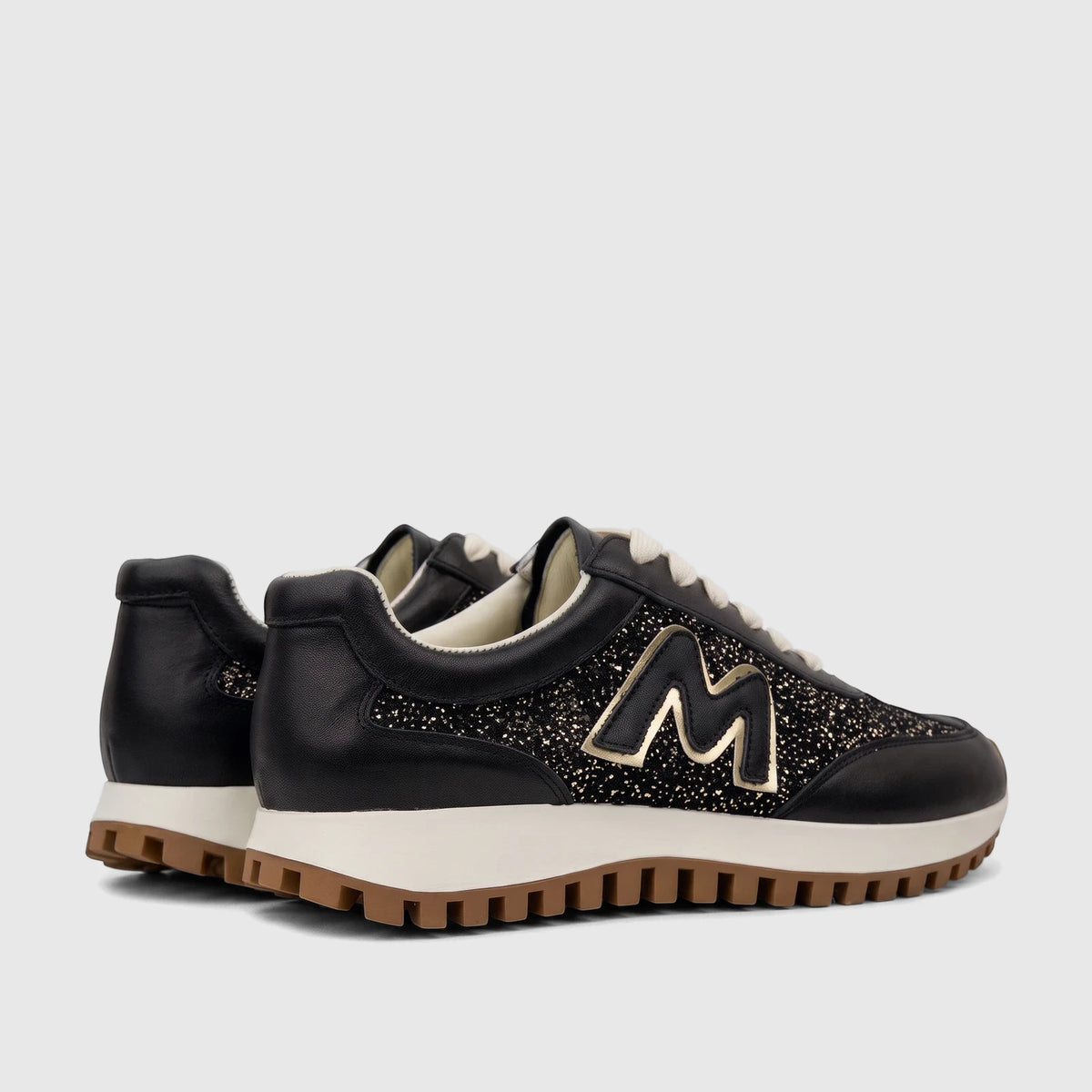 Morbido Ladies Leather Sneaker Black HAS-004. A pair of stylish black leather and glitter women's sneakers with a gold 'M'