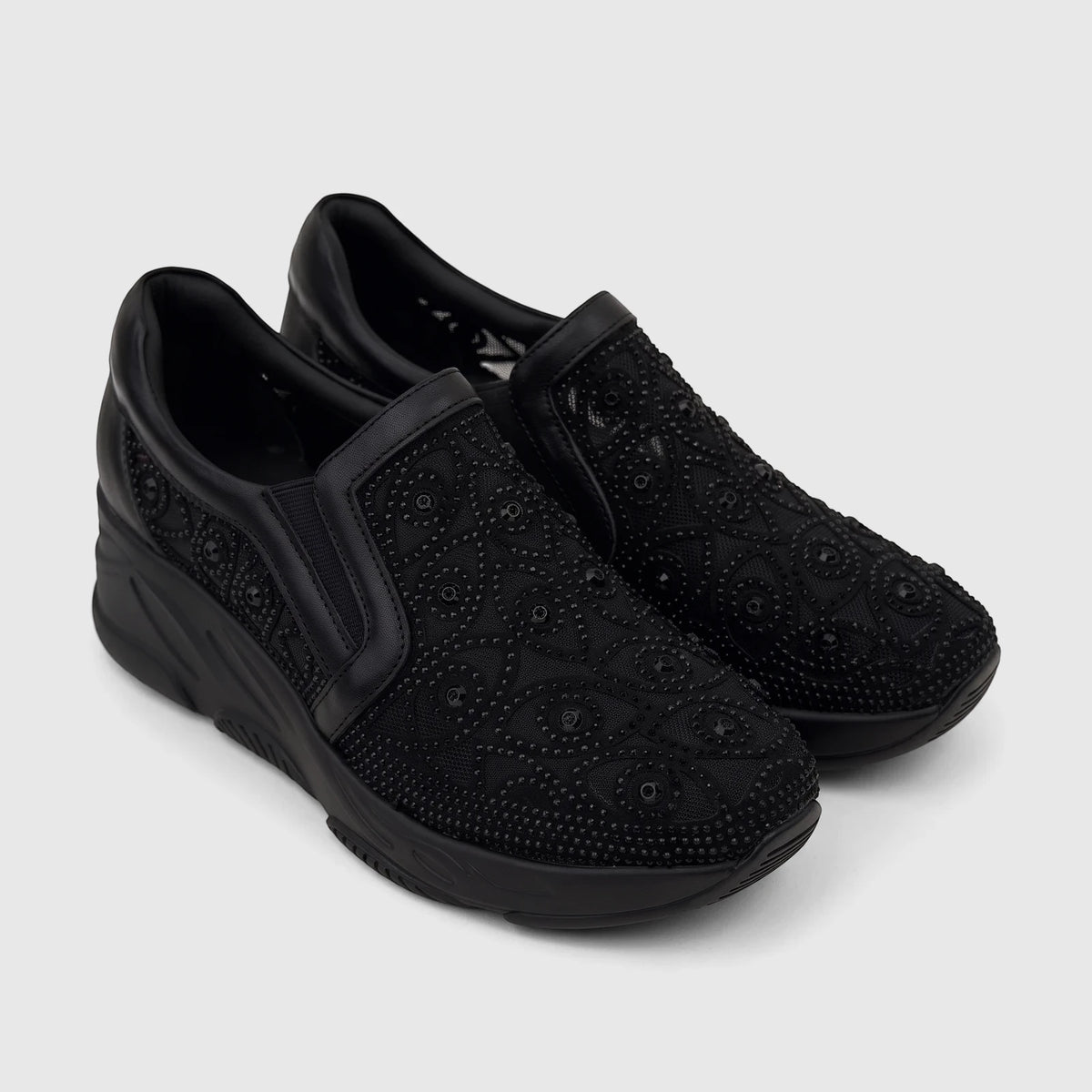 Pair of black Morbido Ladies Leather Sneakers with a studded mesh pattern and platform soles, shown from an elevated angle.