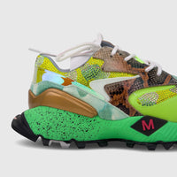 Close-up of a Morbido Ladies Leather Sneaker with bright green, iridescent, and snakeskin textures, adorned with rhinestones.
