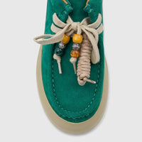 Close-up top view of a Morbido Ladies Leather Sneaker HAS-001 in green suede with decorative beige laces and colorful beads.