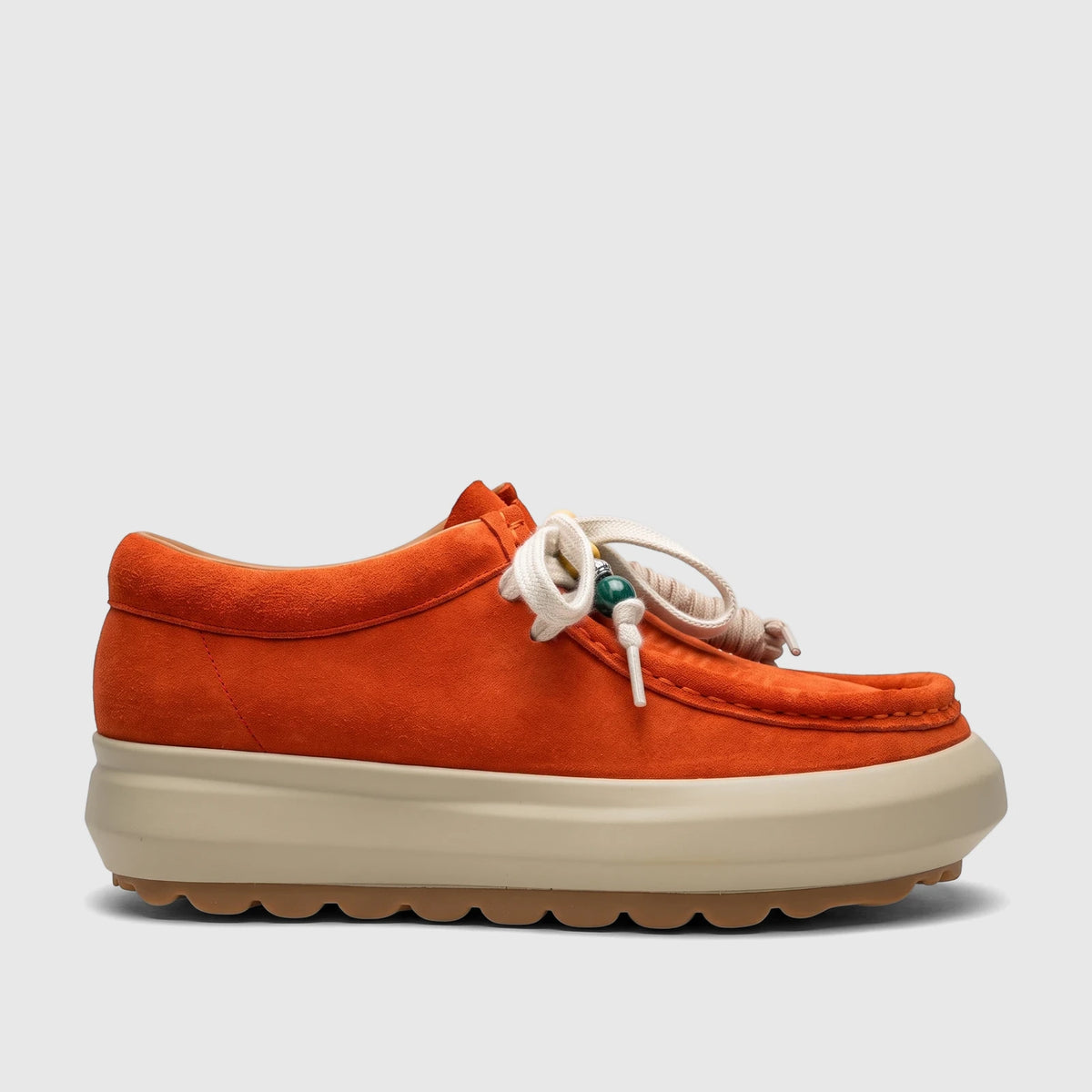 Side view of an orange suede Morbido Ladies Leather Sneaker HAS-001 with white laces and a thick beige sole.
