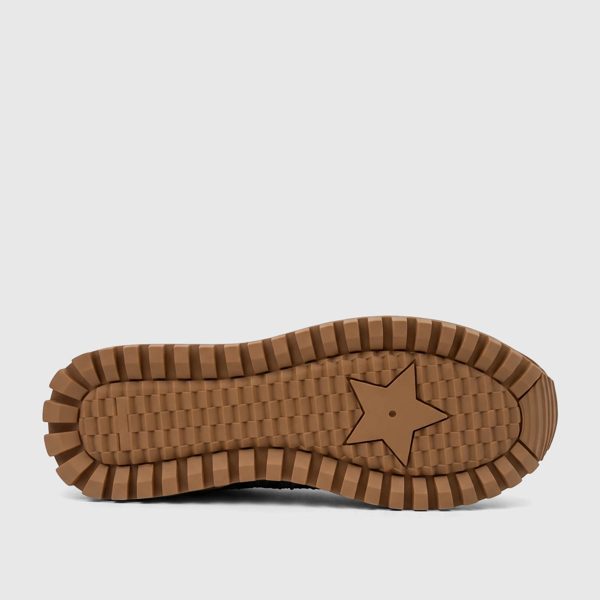 Underside view of a Morbido Ladies Sneaker sole, showing its prominent brown ridged pattern and central star design.