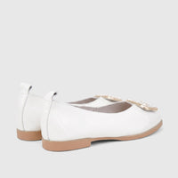 White patent leather women's flats with tan soles and a decorative gold buckle. Side-back view of the Morbido Ladies Leather