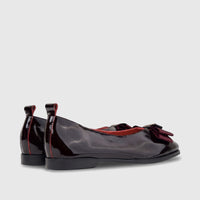 Pair of Morbido Ladies Wine Red patent leather ballet flats with a velvet bow, shown from the side and back view.