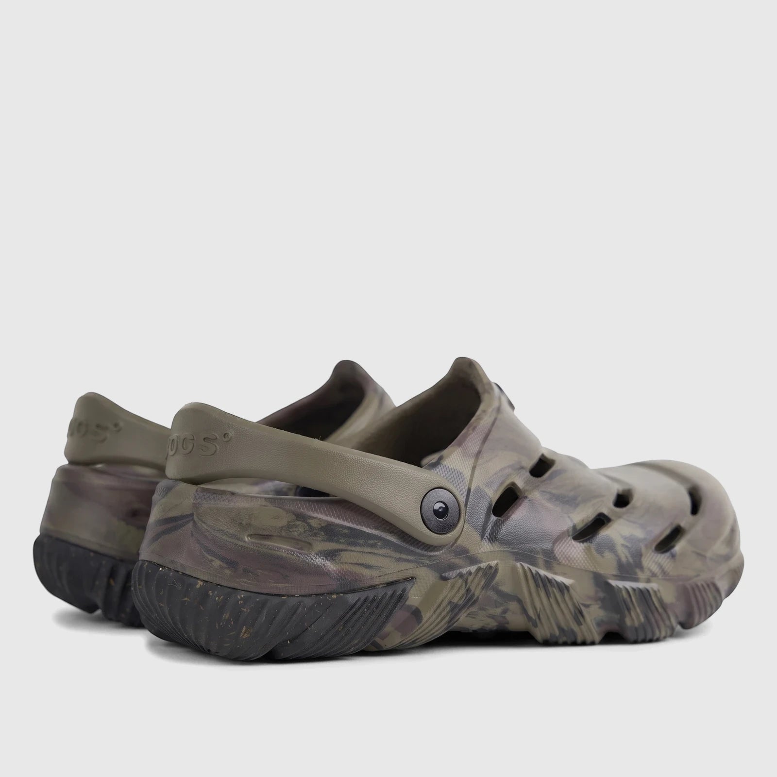 Pair of Bogs by Florsheim Men's Comfort Clog Boga in khaki camouflage, durable slip-on shoes, shown from a rear-quarter view.