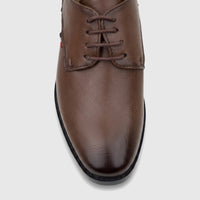 Brown leather lace-up dress shoe for boys, with textured surface and visible stitching, showcased from a top-front
