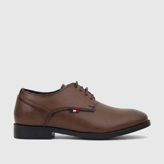 Brown PC Boys dress lace-up shoe with a classic design, black sole, and a subtle red, white, and blue stripe detail.