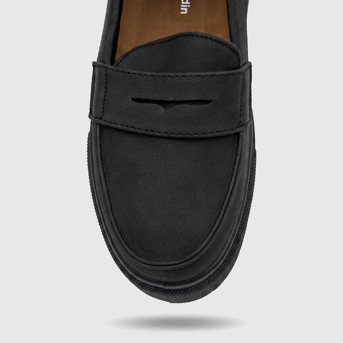 Close-up view of a single PC Boys Youth black casual slip-on loafer shoe, showing its textured faux leather material and