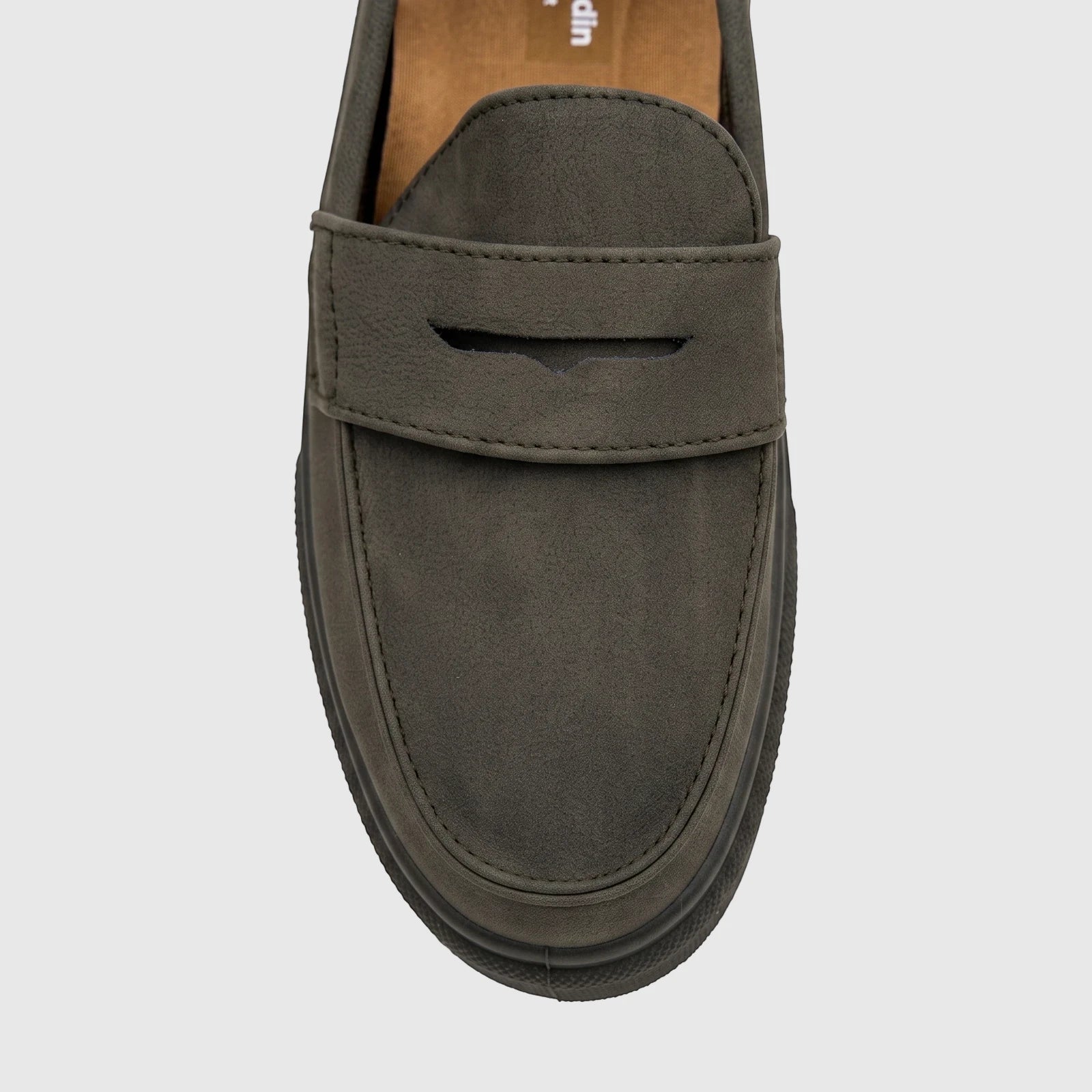 Close-up of an olive green youth casual slip-on loafer shoe with a penny strap and a chunky dark sole.