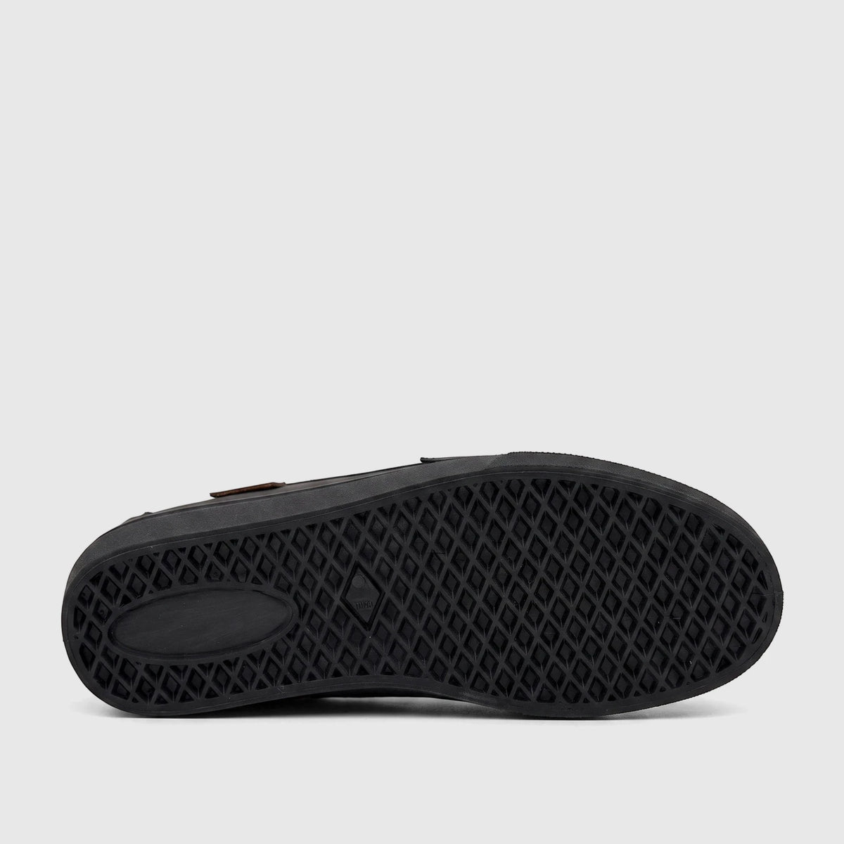 Bottom view of a black PC Boys Youth casual slip-on shoe, showcasing the detailed diamond pattern rubber sole.