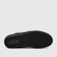 Bottom view of a black PC Boys Youth casual slip-on shoe, showcasing the detailed diamond pattern rubber sole.
