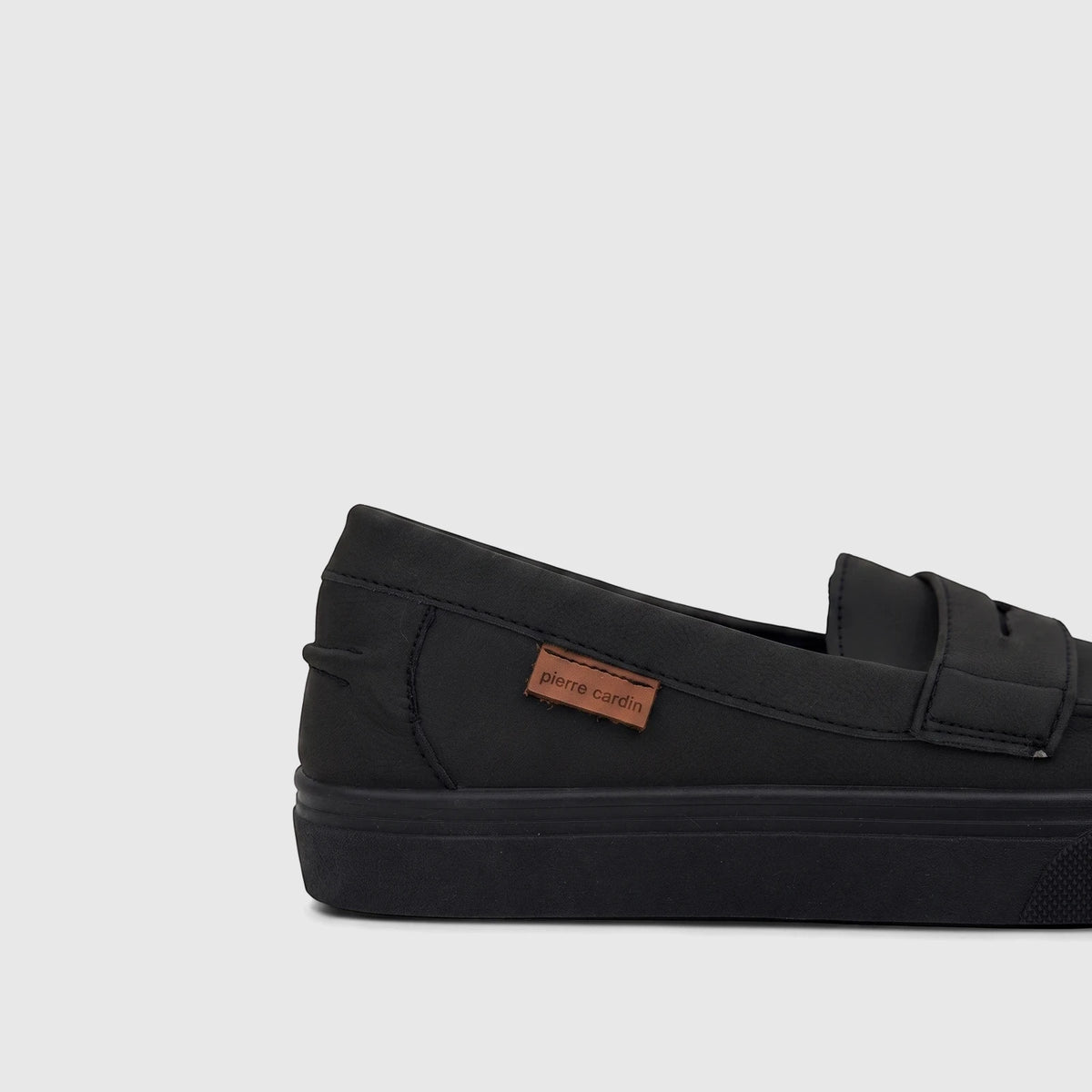 Black Pierre Cardin boys' youth casual slip-on shoe, featuring a matte finish and thick sole, shown from a side view.