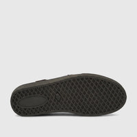 Close up of the dark olive green sole of a PC Boys Youth Casual Slip On shoe, with a diamond tread pattern and an oval