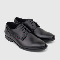A pair of black lace-up dress shoes for boys, made of leather, displayed with a small red, white, and blue detail.