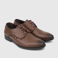 Brown youth boys dress lace-up shoes, size UK2 to UK5, with a tricolor flag detail, on a white background.