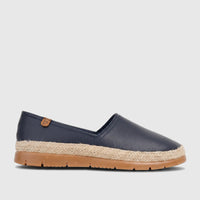 Navy blue leather women's espadrille loafer with woven jute sole and tan rubber bottom, seen from a side view.