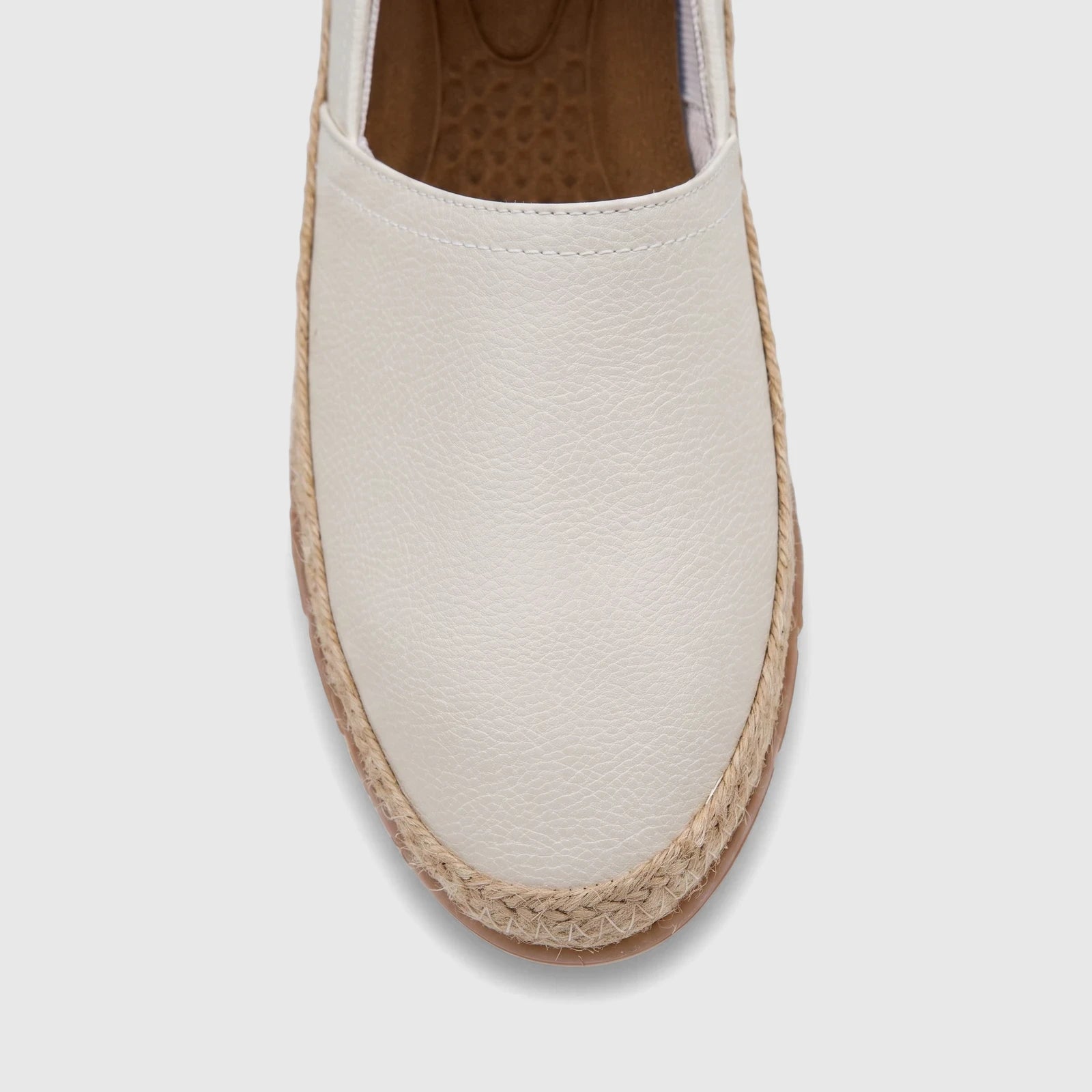 A white PC ladies casual espadrille loafer with a braided jute sole, viewed from directly above on a neutral background.