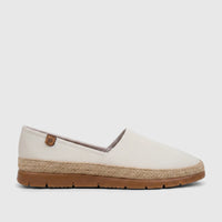 White PC ladies casual espadrille loafer with a braided jute sole and brown rubber bottom, seen from a side view.
