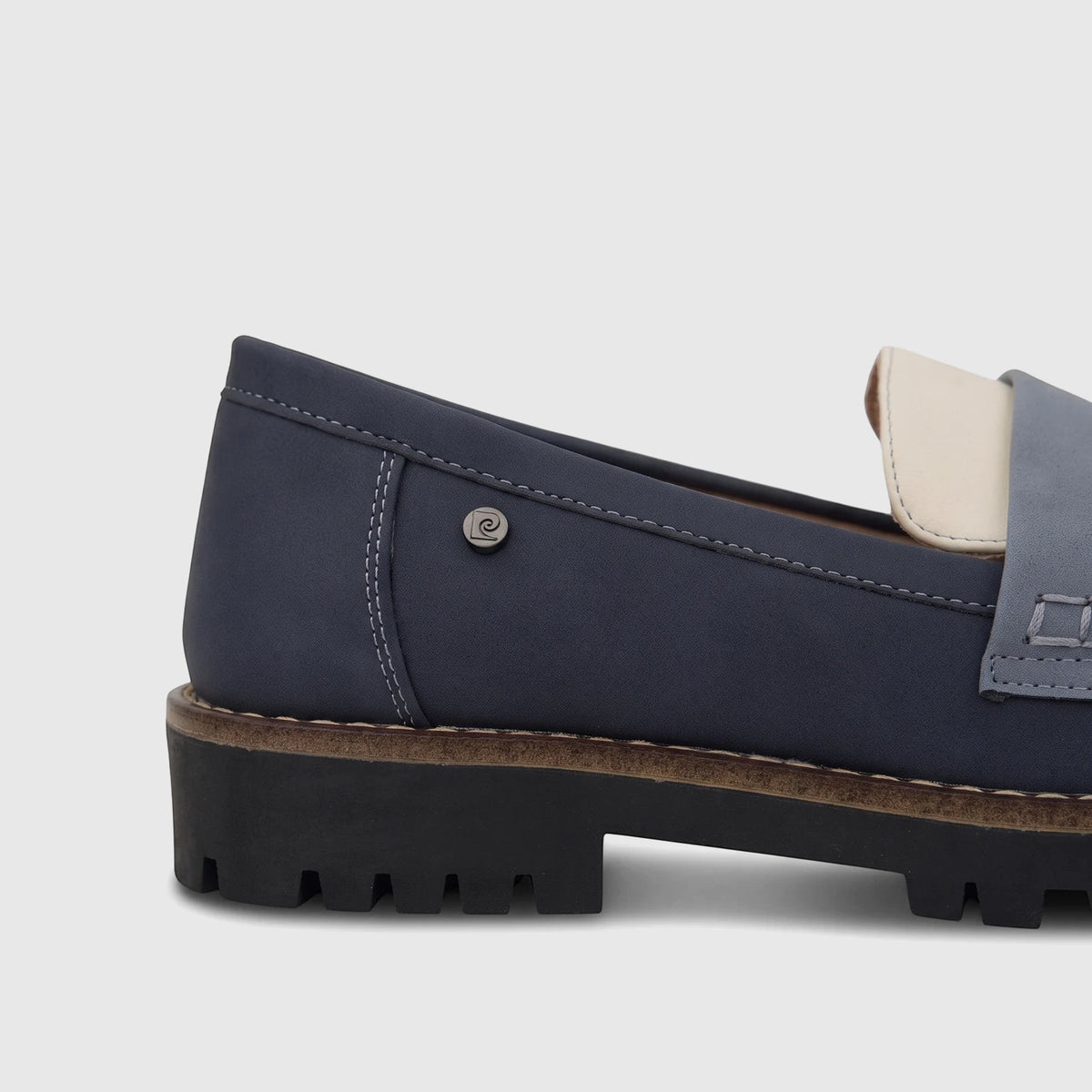 Close-up of a blue and beige PC Ladies Casual Loafer with a thick black sole, featuring white stitching and a subtle logo.