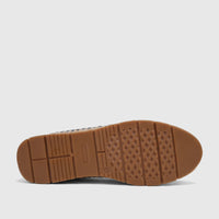 Bottom view of a Pierre Cardin Ladies Casual Loafer in denim, highlighting the brown rubber sole with traction and woven