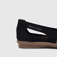 Side view of a black Pierre Cardin ladies' casual pump with a silver metallic strap and a textured beige sole.