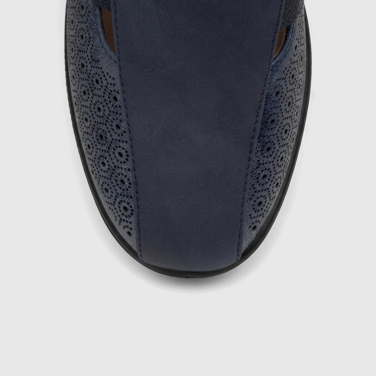 Close-up of a navy blue PC Ladies Casual Pump shoe, made of perforated leather, viewed from the top.