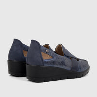 A pair of navy blue PC Ladies Casual Pumps with perforated detail and a comfortable wedge heel, viewed from a rear-side