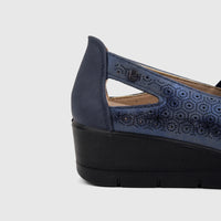 Navy blue PC Ladies Casual Pump PCL10995 with perforated upper and black wedge heel, viewed from the side.