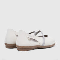 Pair of white Pierre Cardin ladies' casual pumps with silver straps and textured brown soles, shown from a rear-side view.