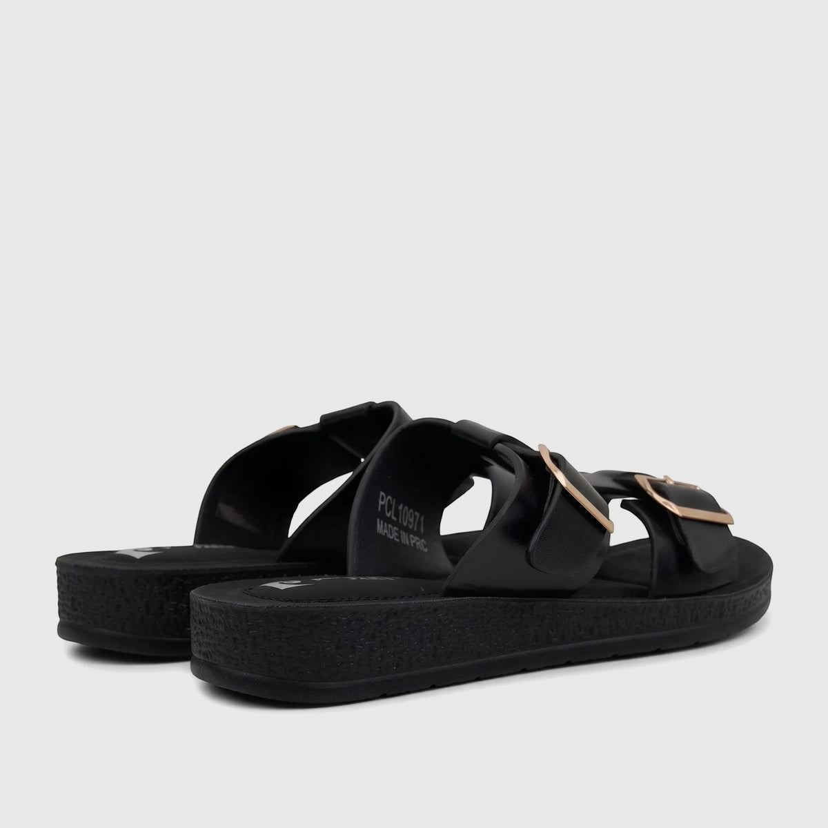 Pair of black PC Ladies Casual Sandals with gold buckles and platform soles, viewed from a slightly low angle.