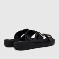 Pair of black PC Ladies Casual Sandals with gold buckles and platform soles, viewed from a slightly low angle.