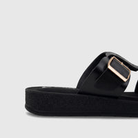 Close-up of a PC Ladies Casual Sandal PCL10971 in black, featuring a thick platform sole and a gold buckle on the strap.