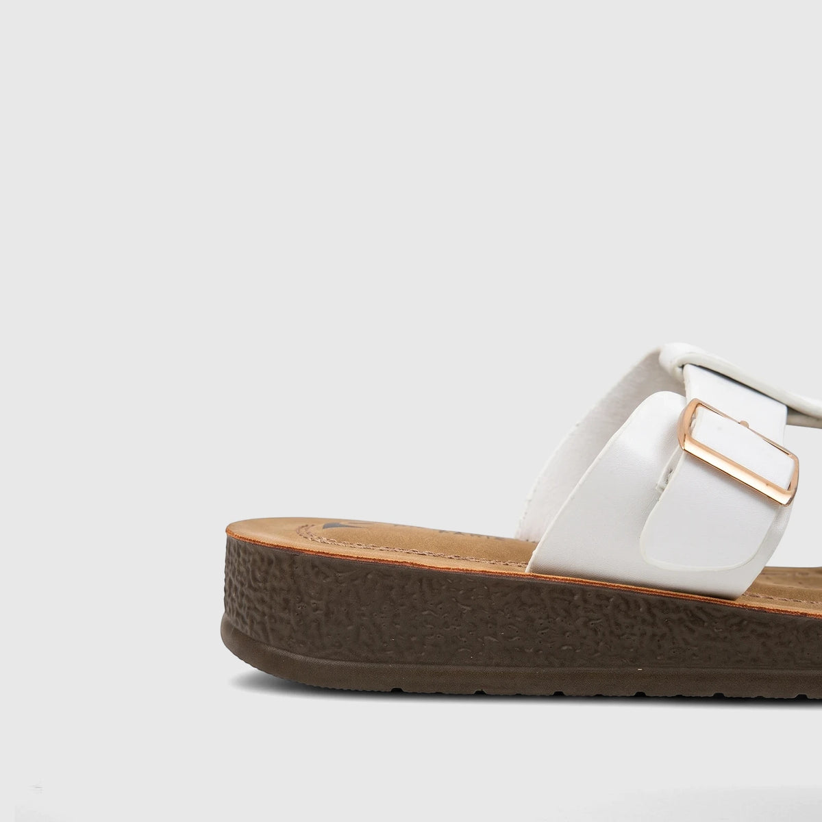 Side view of a white PC Ladies Casual Sandal PCL10971 with a textured brown sole and a gold buckle on the strap.