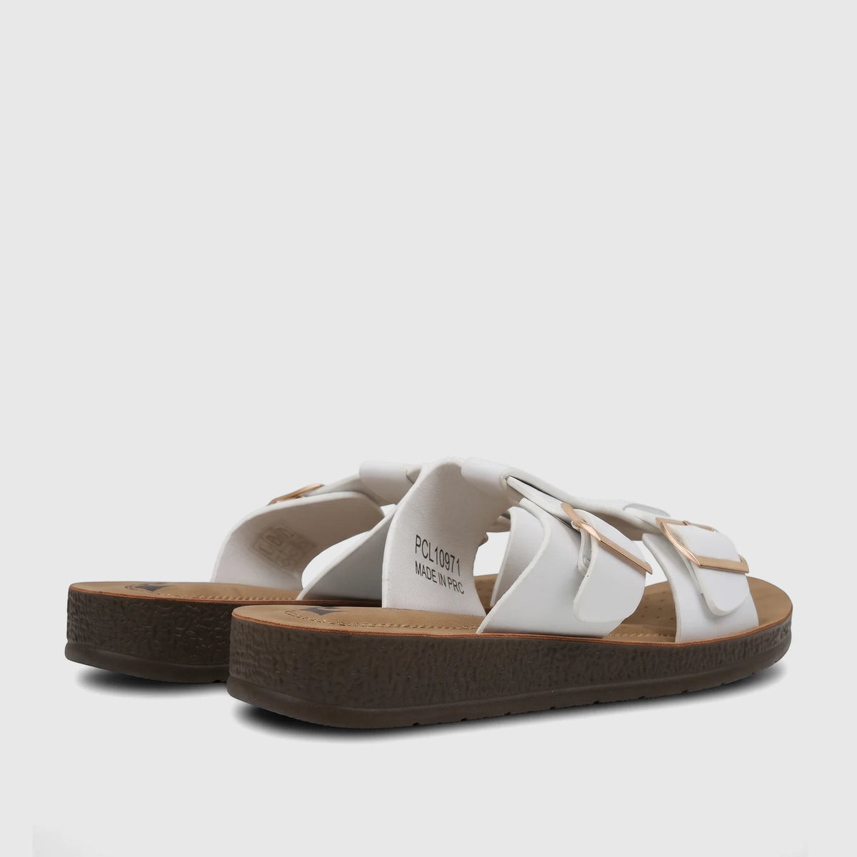 A pair of white PC Ladies Casual Sandals with platform soles and gold buckles, viewed from the back-side.
