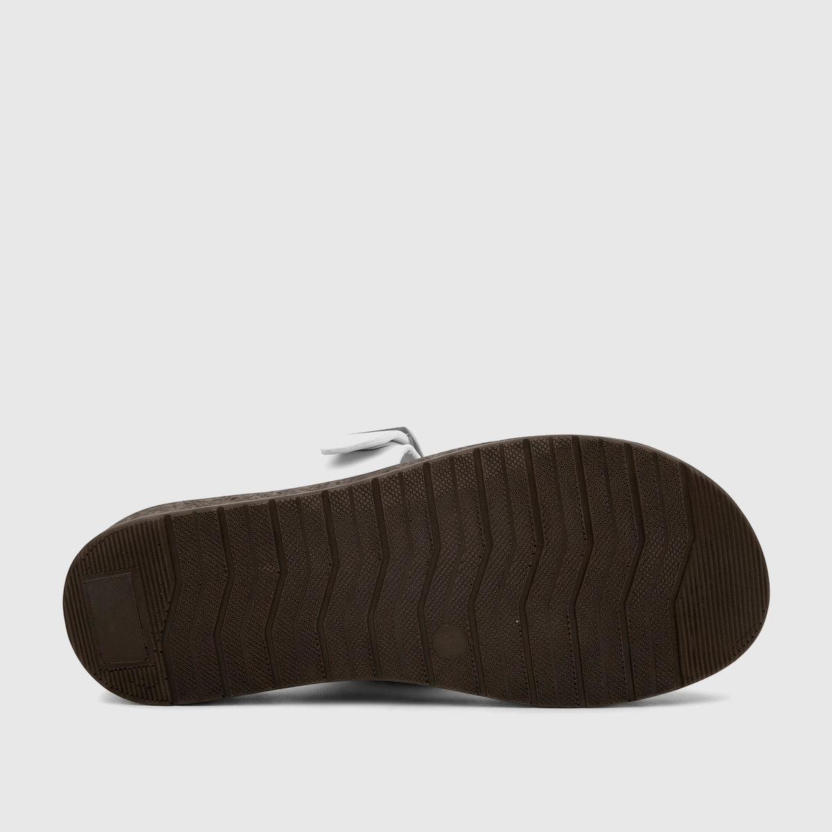 Bottom view of a white PC Ladies Casual Sandal PCL10971, featuring a textured brown sole and visible white straps.